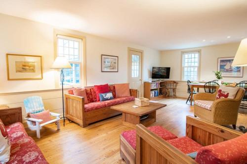a living room with couches and a table at Fantastic Home by Eldridge Park in Orleans