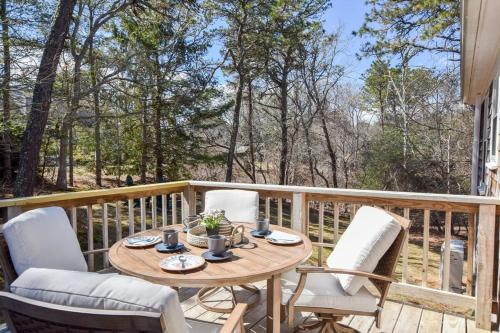 a wooden deck with a table and chairs at Fully Updated Home w Great Outdoor Space in Chatham
