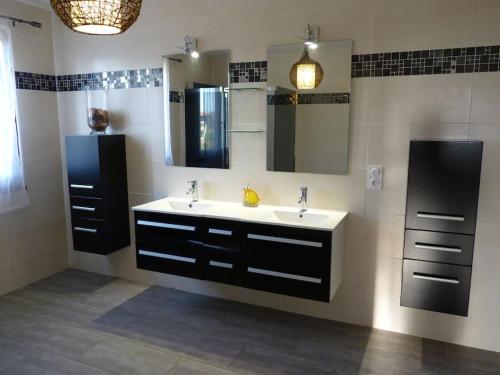 a bathroom with a sink and a mirror at Villa de standing proche d'Argelès sur Mer in Saint-André