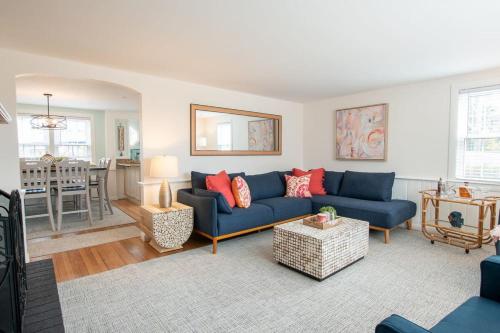 a living room with a blue couch and a table at Stellar Home with Hot Tub & Movie Room in Chatham