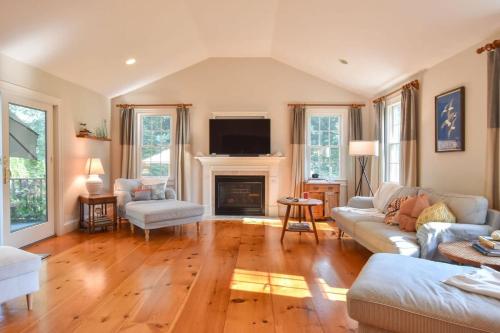 a living room with a couch and a fireplace at 1 Mile from Downtown Chatham Walk to Pier in Chatham