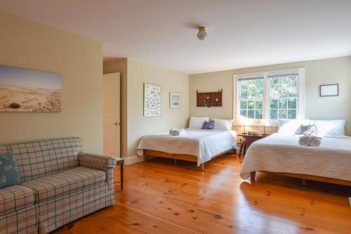 a living room with two beds and a couch at 1 Mile from Downtown Chatham Walk to Pier in Chatham