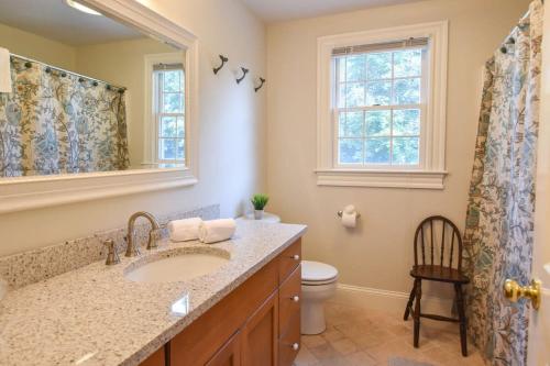 bagno con lavandino, servizi igienici e specchio di 1 Mile from Downtown Chatham Walk to Pier a Chatham