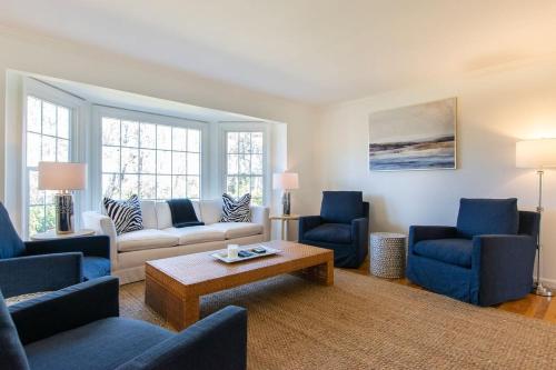a living room with blue chairs and a couch at Gorgeous Home with Game Room Dog Welcome in Chatham