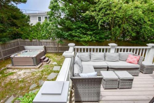 a patio with a couch and a hot tub at Perfect for Group w Kids & Dogs w Hot Tub in Chatham