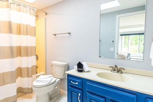 a bathroom with a sink and a toilet and a mirror at 5 Min Walk to Red River Beach in Harwich