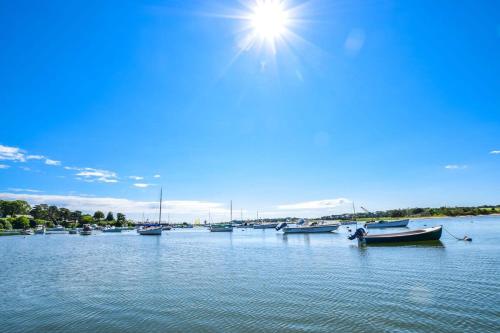 a group of boats are docked in a harbor at 5 Min Walk to Red River Beach in Harwich