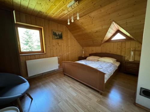 a bedroom with a bed in a wooden cabin at Chill on Hill - Szczyrk in Szczyrk