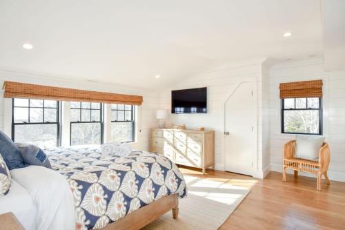 a bedroom with a bed and a television in it at Gorgeous Home 2 Min Walk to Beach in Harwich