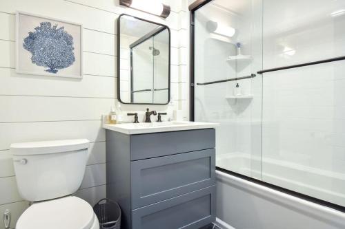 a bathroom with a toilet and a sink and a shower at Gorgeous Home 2 Min Walk to Beach in Harwich