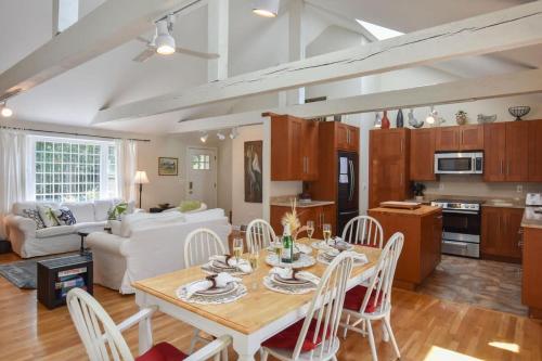 a kitchen and living room with a table and chairs at Pond Front Home with Private Dock in Brewster