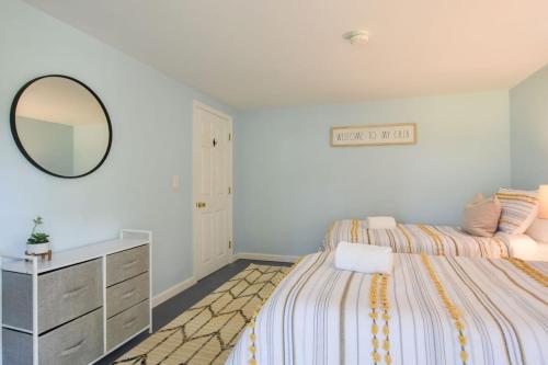 a bedroom with a bed with a mirror and a dresser at Pond Front Home with Private Dock in Brewster