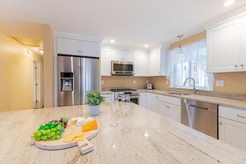 a kitchen with a counter with a bowl of fruit on it at Spacious Home by Beach Dog Welcome in Brewster