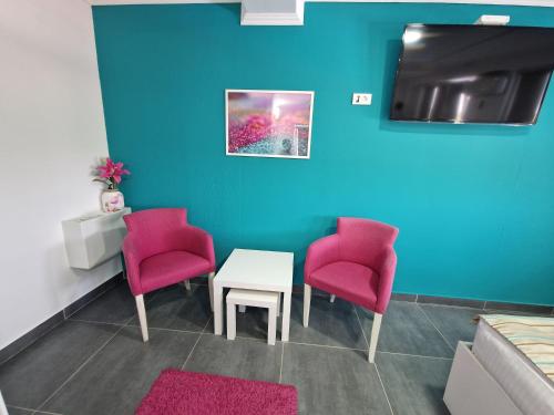 a waiting room with two chairs and a table at Flamingo Resort in Belgrade