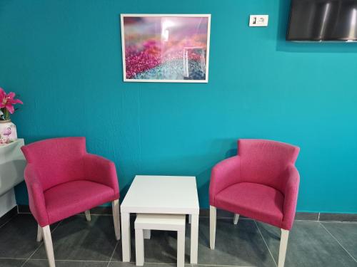 a waiting room with two chairs and a table at Flamingo Resort in Belgrade