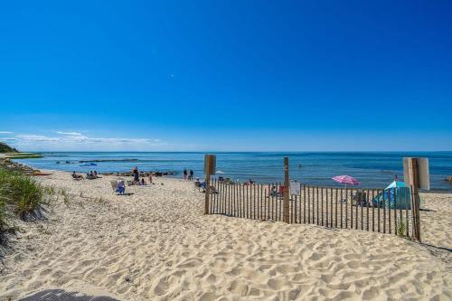 a beach with people on the sand and the ocean at Steps to Freshwater Beach Kayaks Sauna in Brewster