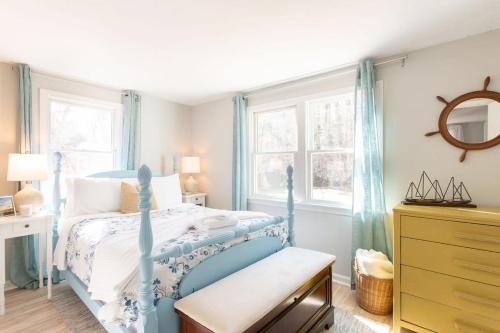 a bedroom with a blue bed and a window at Stunning Home with Wet Bar Dog Welcome! in Brewster