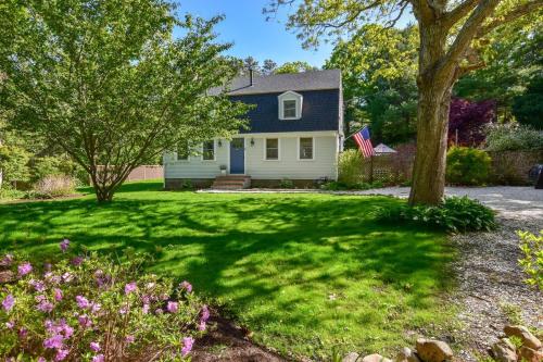 a white house with a blue door and a yard at Stunning Home with Wet Bar Dog Welcome! in Brewster