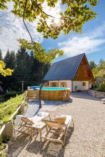 a house with a swimming pool in front of it at Forest Tale - Šumska priča in Crni Lug