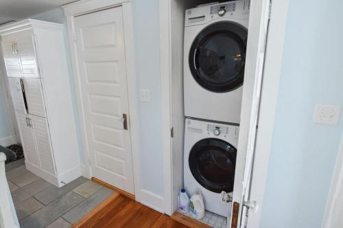 a laundry room with a washer and dryer at Walk to Beach at Historic Sears Kit Home in Dennis