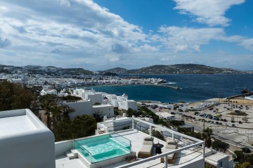 a view of a city and the ocean from a house at Numi Suites in Mýkonos City
