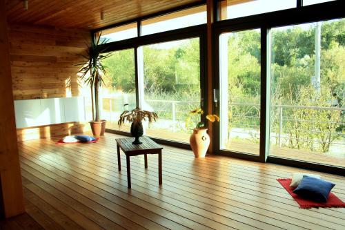 a living room with a wooden floor and large windows at Il Bevaio Di Corleone in Corleone