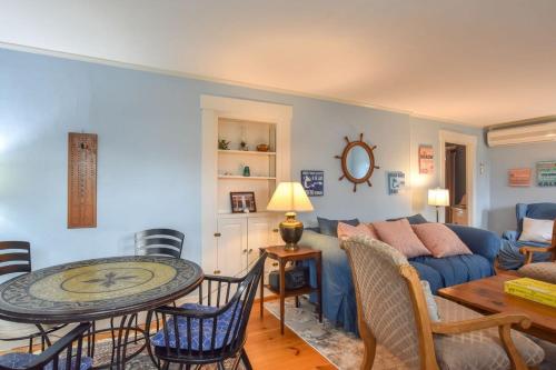 a living room with a blue couch and a table at Waterfront Fun Dogs Welcome in Dennis