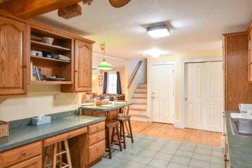 a kitchen with wooden cabinets and a counter top at Waterfront Fun Dogs Welcome in Dennis