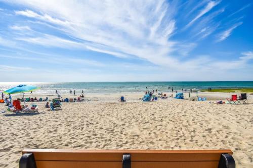 a beach with a lot of people and the ocean at Pristine waterfront oasis plus game room jacuzzi and home office in Orleans