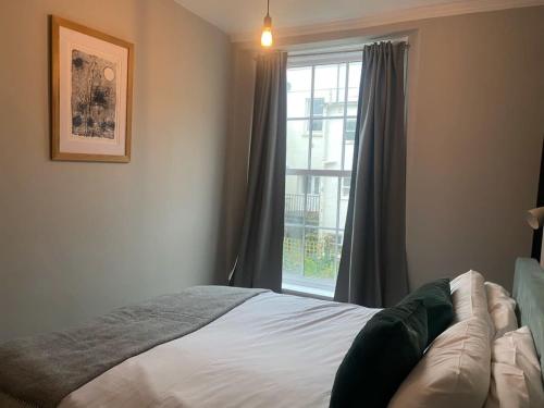 a bedroom with a bed and a window at Charming and Stylish Redland One Bedroom Apartment in Bristol