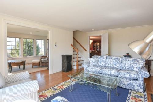 a living room with a couch and a glass table at Water Views & Private Tennis Court in Barnstable