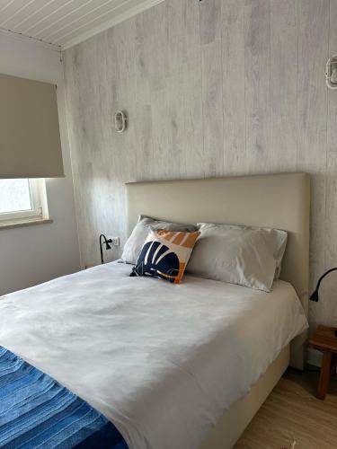 a bedroom with a large white bed with two pillows at BerlengaBed&Breakfast in Peniche