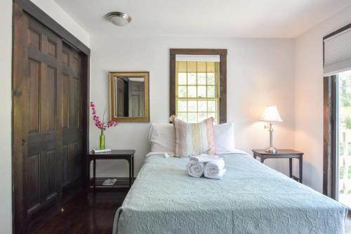 a bedroom with a bed with two towels on it at Spacious Private Home 1 mi to Downtown Wellfleet in Wellfleet