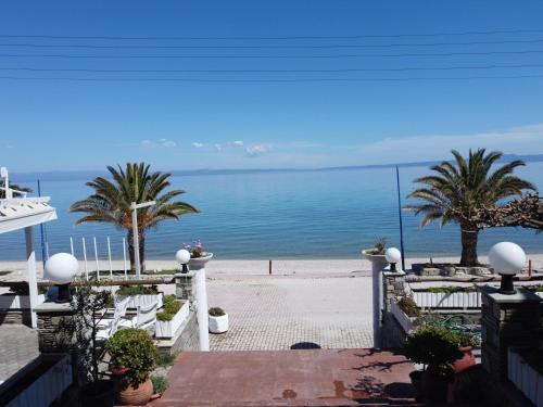 a view of the ocean from the balcony of a house at Polychrono Beach Hotel in Polykhrono
