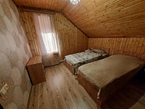 a small room with two beds and a window at Forest Gamp in Dilijan