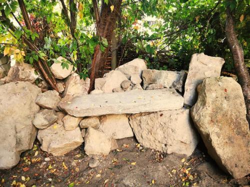 a stone bench sitting on a pile of rocks at Ferienhaus Emilia in Wilthen
