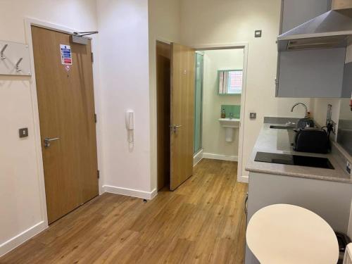 a kitchen with a counter top and a wooden floor at Harford House Studios 11- Hopewell in Bristol