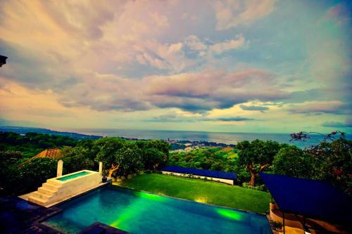 a house with a swimming pool with a view at Villa Puri Soka in Pabean Buleleng