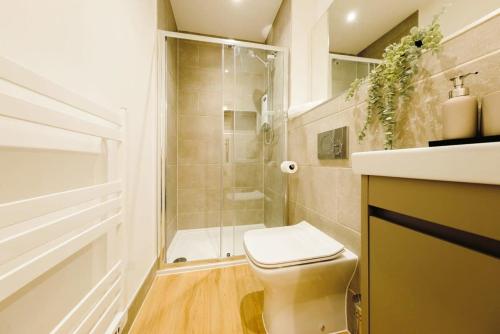 a bathroom with a shower and a toilet and a sink at Grange Road Studio 4 in Bristol