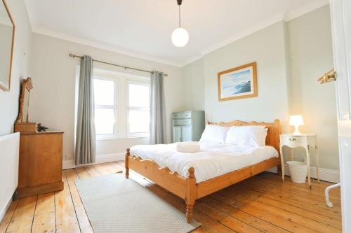 a bedroom with a bed and a large window at Spacious 2 storey penthouse flat, fantastic views! in Bristol
