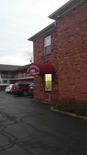 a brick building with a sign that reads first monopoly inn at Old Bardstown Inn in Bardstown