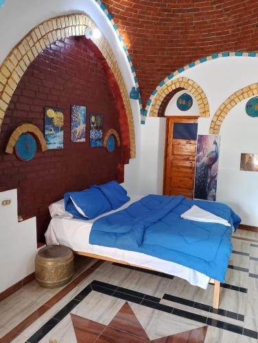 a bedroom with a bed in a brick wall at Golden Palace Garden in Luxor