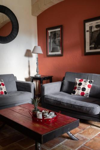 a living room with two couches and a coffee table at HOTEL et APPARTEMENTS DOMAINE DES CLOS - Teritoria in Beaucaire