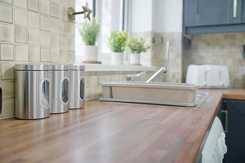 a kitchen with two trash cans next to a sink at Deerness Viewpoint-Your Scenic Retreat in Brandon in Durham