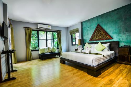 a large bedroom with a bed and a couch at Cocoville Phuket - SHA Plus in Chalong
