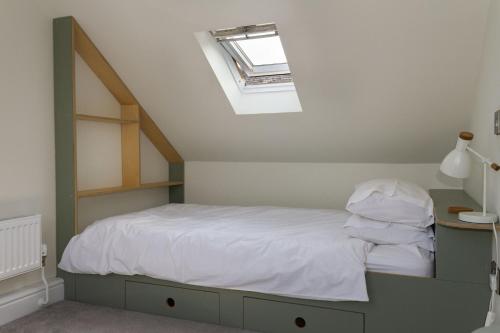 a bedroom with a bed with a skylight at Skerrow in New Galloway