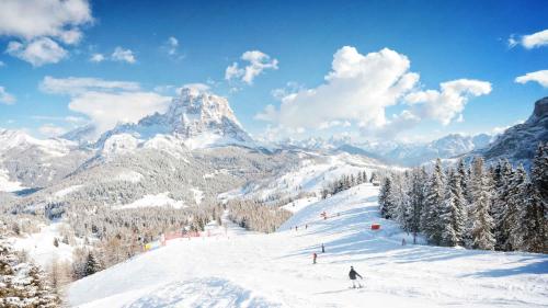 a group of people skiing down a snow covered mountain at Antico Borgo Palue in Sottoguda