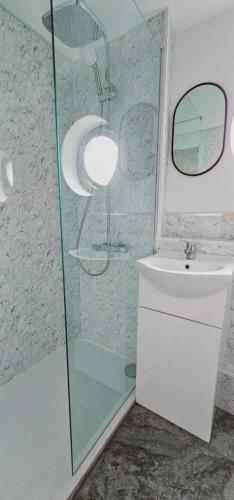 a bathroom with a shower and a sink at Laburnum Holiday Cottage in Tunstead