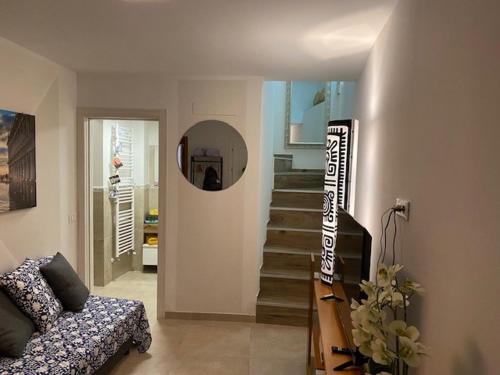 a living room with a couch and a staircase at CasaBella Chioggia casa indipendente con corte in Chioggia