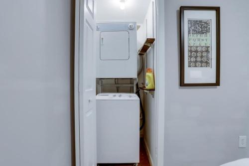 a small white refrigerator in a small kitchen at Beautiful 2 Bedroom across from The House of Representatives in Washington